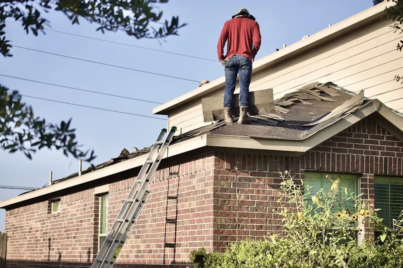 Professional roofer working on a residential roof in Amber Wood Estates